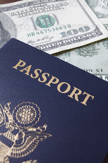 Close-up of passport and dollar banknotes. Photo : Winslow Productions