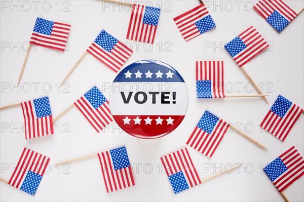 Studio shot of vote pin and small american flags. Photo : Winslow Productions