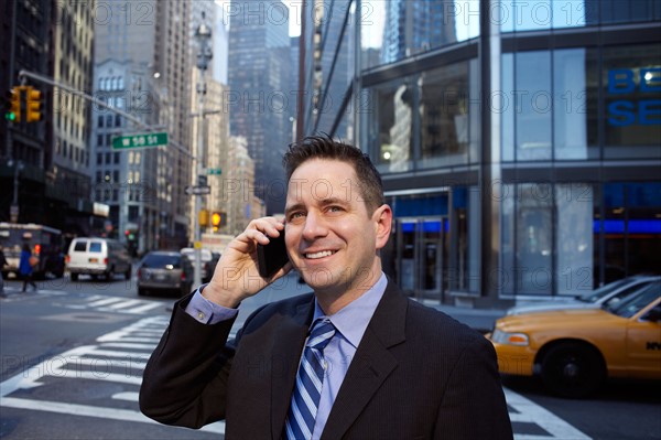 USA, New York, New York City. Portrait of businessman in city. Photo : Winslow Productions