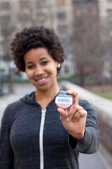 USA, New York, New York City. Portrait of woman with vote pin. Photo : Winslow Productions