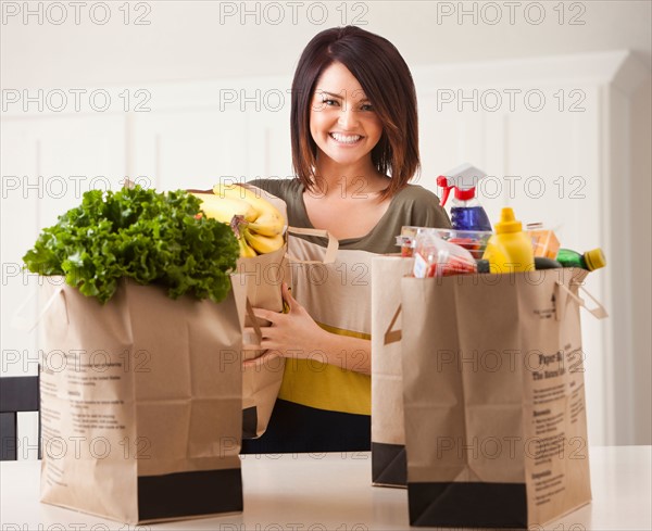 Young woman with paper bags after shopping. Photo : Mike Kemp