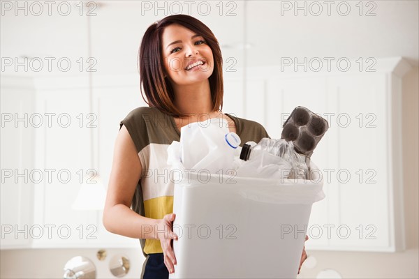 Portrait of young woman with waste bin. Photo : Mike Kemp