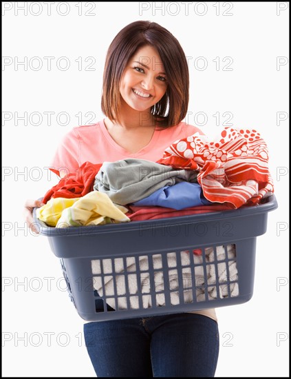 Young woman with laundry basket. Photo : Mike Kemp
