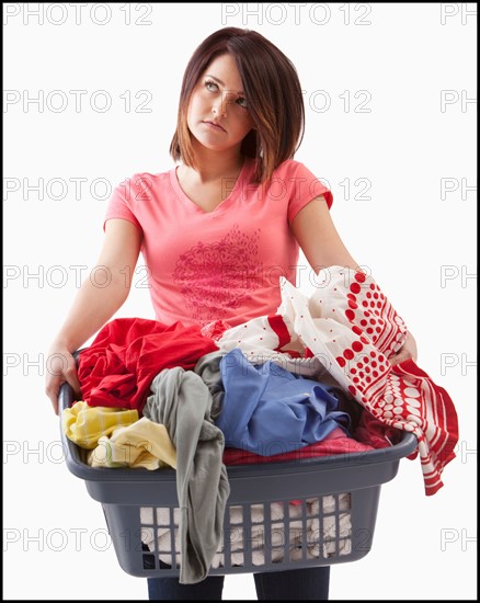 Young woman with laundry basket. Photo : Mike Kemp