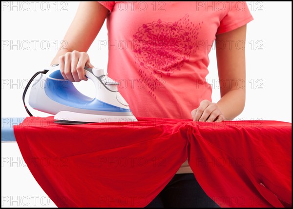 Young woman ironing. Photo : Mike Kemp