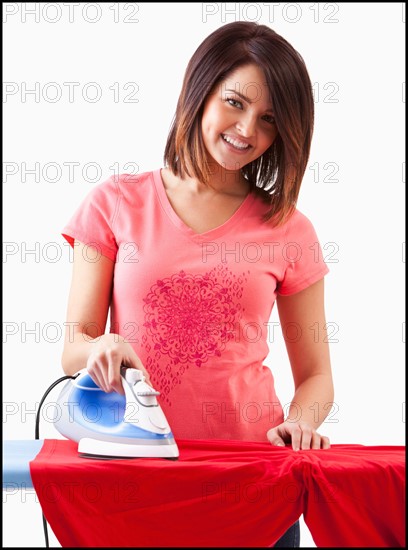 Young woman ironing. Photo : Mike Kemp