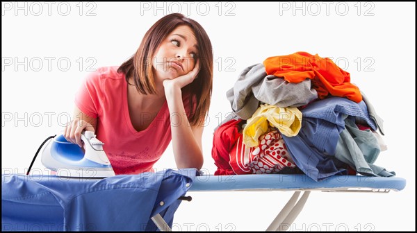 Young woman ironing. Photo : Mike Kemp