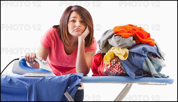 Young woman ironing. Photo : Mike Kemp