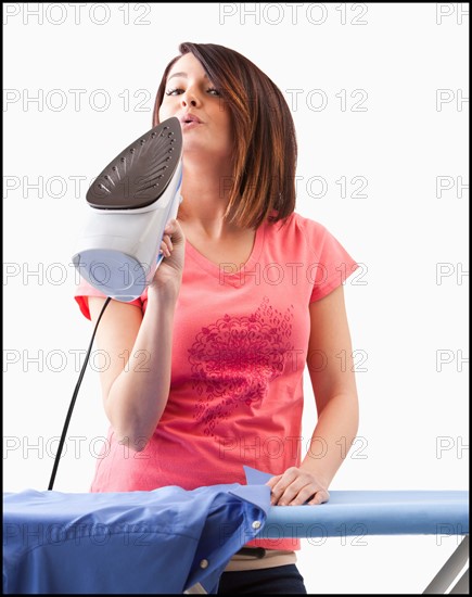 Young woman ironing. Photo : Mike Kemp