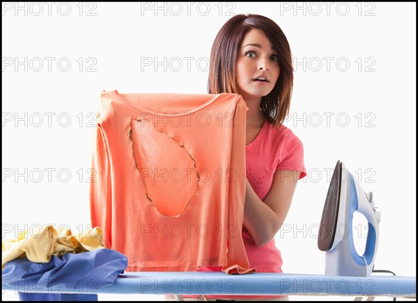 Young woman ironing. Photo : Mike Kemp