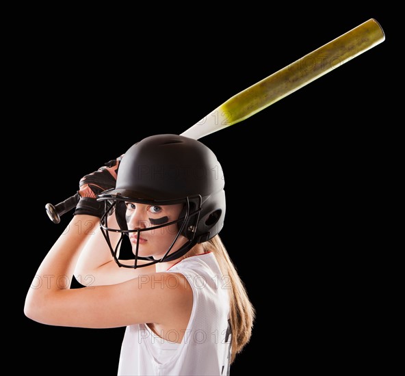 Portrait of girl (12-13) plying softball. Photo : Mike Kemp