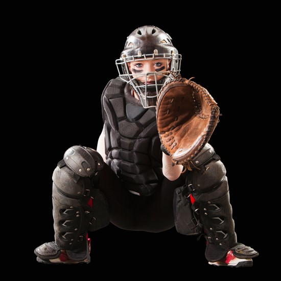 Girl (12-13) plying softball, studio shot. Photo : Mike Kemp