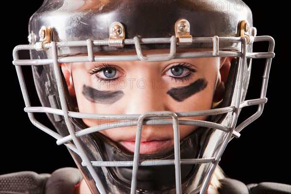 Portrait of girl (12-13) plying softball. Photo : Mike Kemp