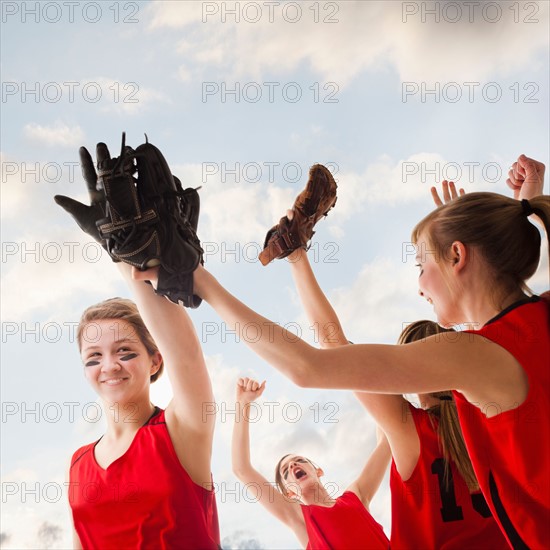 Girls (12-13) celebrating during playing softball. Photo : Mike Kemp