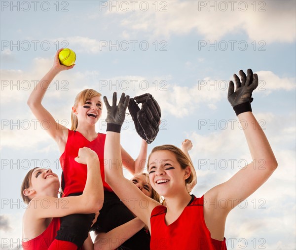 Girls (12-13) celebrating during playing softball. Photo : Mike Kemp