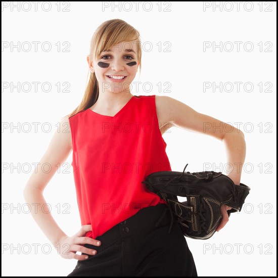 Portrait of girl (12-13) plying softball. Photo : Mike Kemp