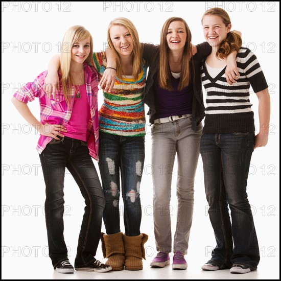 Studio shot of four happy girls (12-13). Photo : Mike Kemp