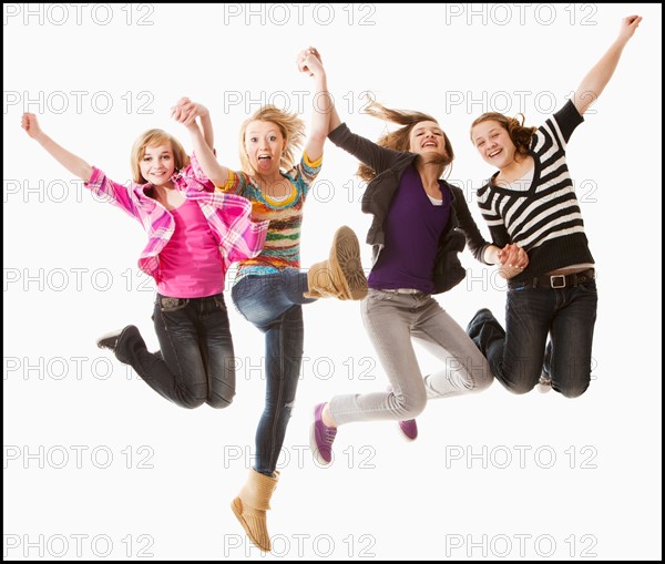 Studio shot of four happy girls (12-13). Photo : Mike Kemp