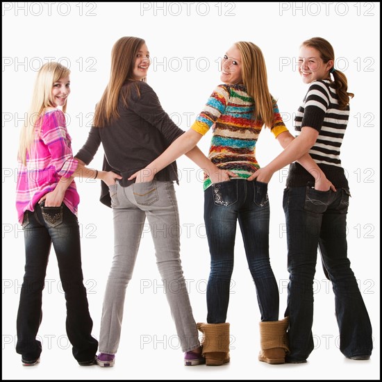 Studio shot of four happy girls (12-13). Photo : Mike Kemp