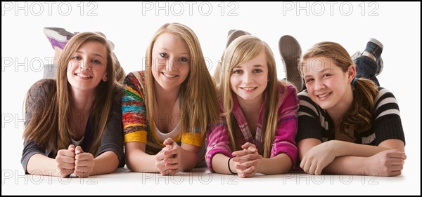 Studio shot of four happy girls (12-13). Photo : Mike Kemp