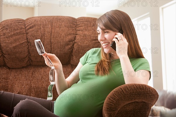 Portrait of pregnant woman watching ultrasonography scan. Photo : Mike Kemp