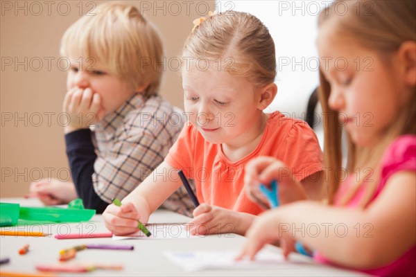 Children (4-5)  drawing in kindergarten. Photo : Mike Kemp