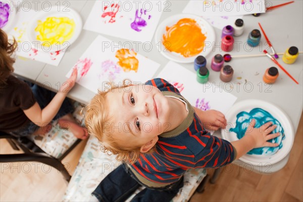 High angle view of boy (4-5) making palm print. Photo : Mike Kemp