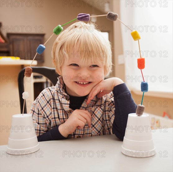 Boy (4-5) with his craft work. Photo : Mike Kemp