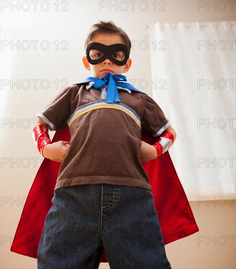 Low angle view of boy (6-7) in fancy dress costume. Photo : Mike Kemp