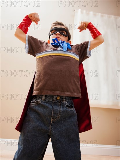 Low angle view of boy (6-7) in fancy dress costume. Photo : Mike Kemp