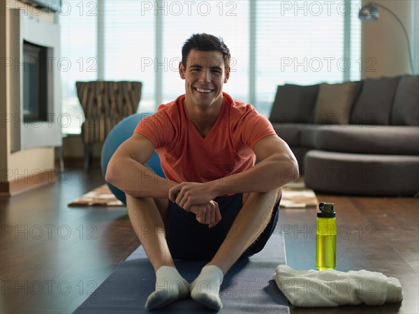 Portrait of Young man exercising at home. Photo : Dan Bannister