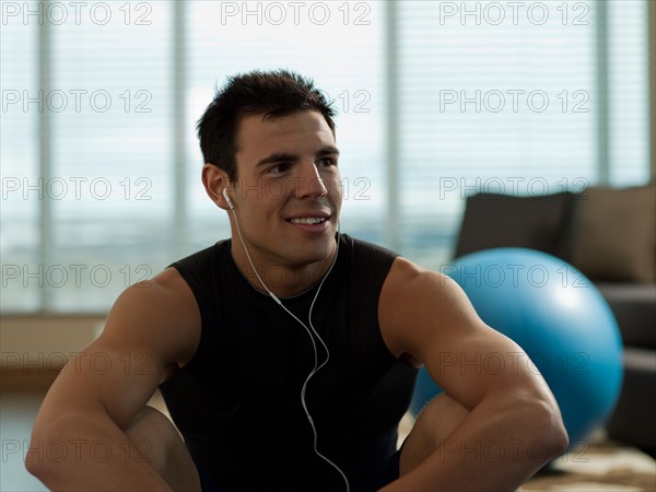Portrait of Young man exercising at home. Photo : Dan Bannister