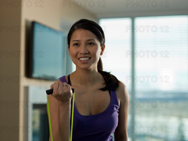 Portrait of Young woman exercising at home. Photo : Dan Bannister
