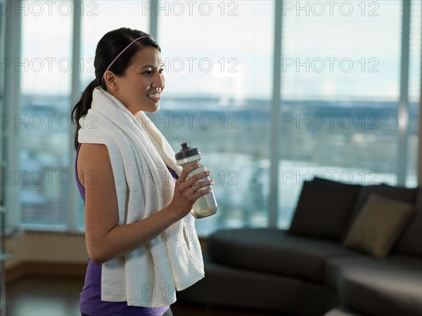 Side view of Young woman exercising at home. Photo : Dan Bannister