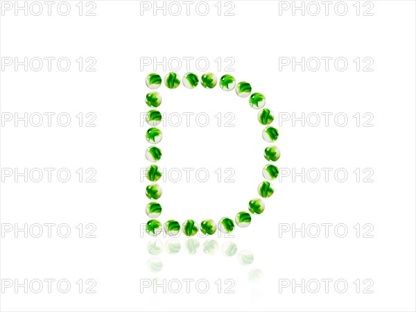 Studio shot of green marbles arranged in Exclamation Point. Photo : David Arky