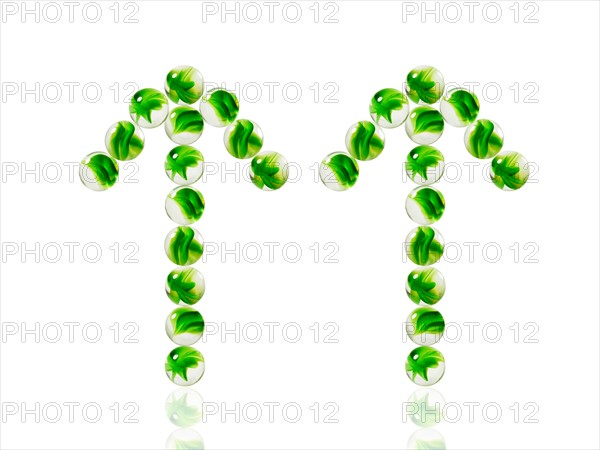 Studio shot of green marbles arranged in Exclamation Point. Photo : David Arky