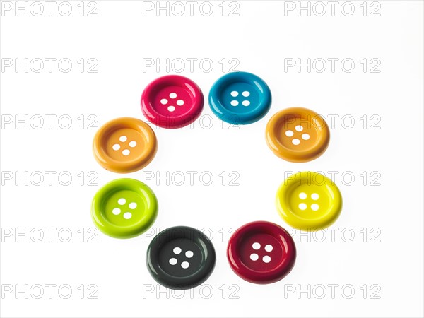 Studio shot of multi colored buttons arranged in circle. Photo : David Arky