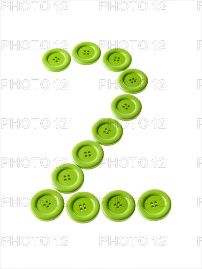 Studio shot of green buttons arranged in number two. Photo : David Arky