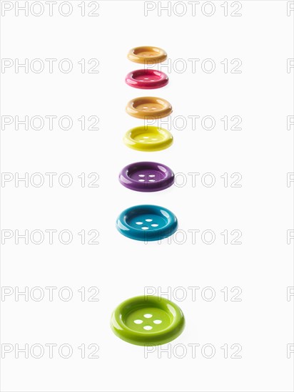Studio shot of multi colored buttons in a row. Photo : David Arky