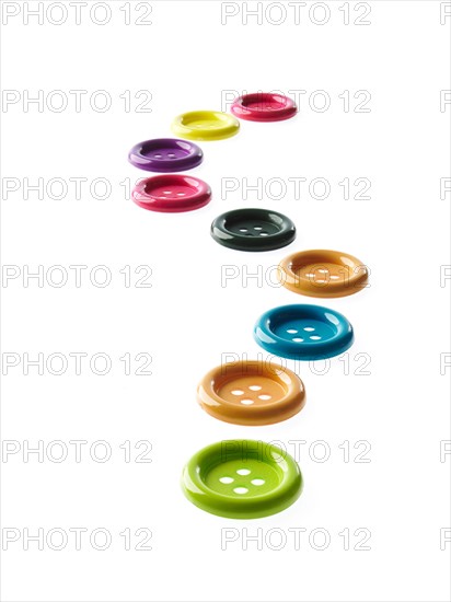 Studio shot of medium group of multi colored buttons. Photo : David Arky