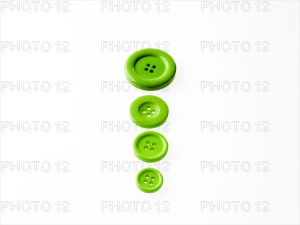 Studio shot of green buttons in a row. Photo : David Arky