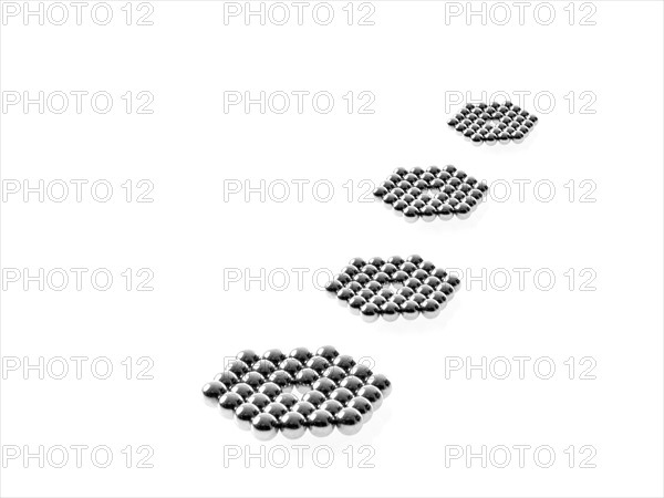 Studio shot of Pachinko balls arranged in single row of hexagons. Photo : David Arky