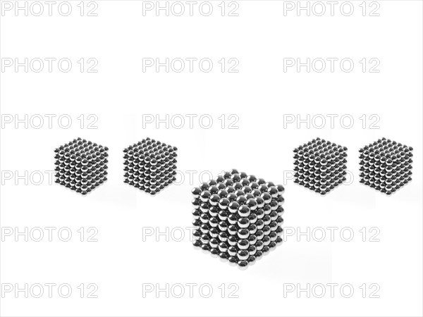 Studio shot of Pachinko balls arranged in group of cubes. Photo : David Arky