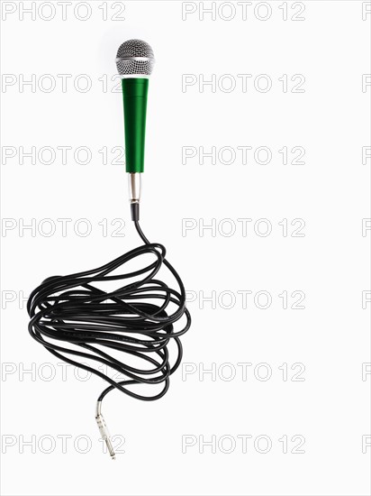 Studio shot of microphone and microphone cable on white background. Photo : David Arky