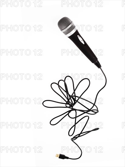 Studio shot of microphone and microphone cable on white background. Photo : David Arky