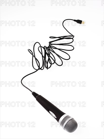 Studio shot of microphone and microphone cable on white background. Photo : David Arky