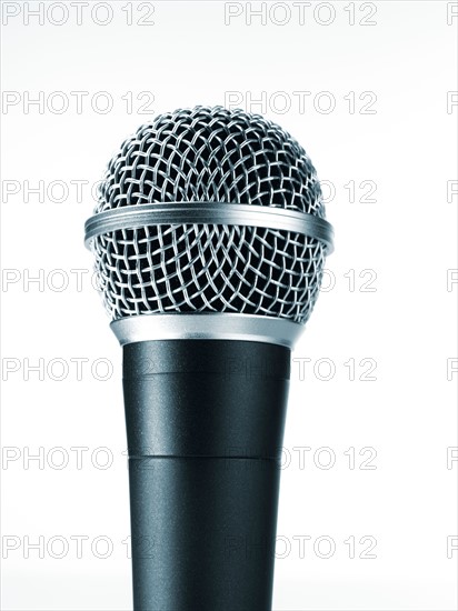 Studio shot of microphone on white background. Photo : David Arky