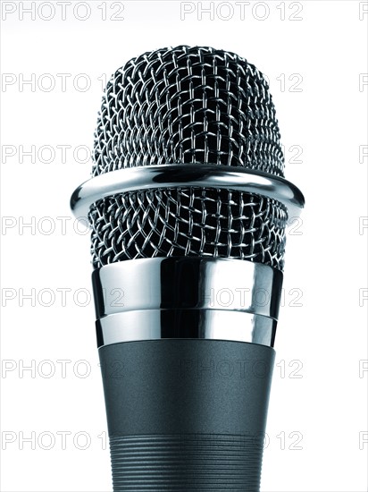 Studio shot of microphone on white background. Photo : David Arky