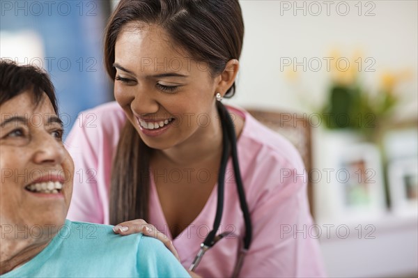 Young female nurse attending patient. Photo : Tim Pannell