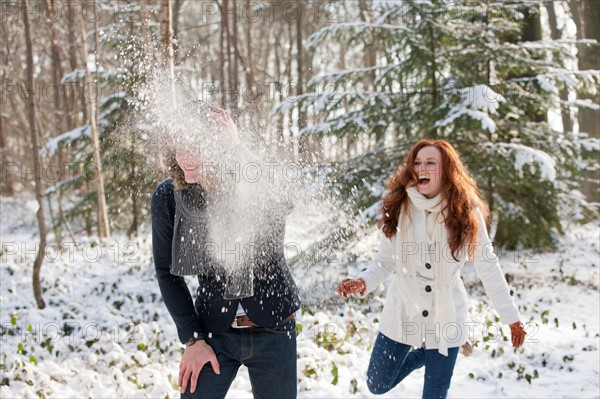 Netherlands, North-Brabant, Hilvarenbeek. Young couple are having snowball fight. Photo : Jan Scherders
